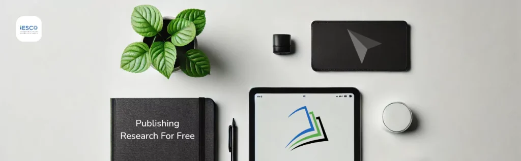 a flat lay arrangement on a light-colored surface. On the left, there is a black notebook with the words "Publishing Research For Free" written on it. Above the notebook, there is a small potted plant with green leaves. To the right of the plant, there is a black cylindrical object, possibly a small speaker or container, and a black rectangular item with a paper airplane icon on it, which could be a wallet or a phone case. In the center, there is a tablet displaying a logo with stylized pages in blue, green, and black. To the right of the tablet, there is a round white object, possibly a coaster or a lid. In the top left corner of the image, there is a logo with the text "IESCO" and "International Engineering and Science Consortium" written below it.